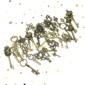 Collection of vintage bronze alloy keys with heart and crown designs on starry background