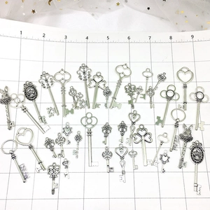 Macro shot of assorted vintage alloy key pendants with size scale and Dream engraving