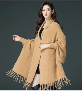 Detail of camel faux mink fur shawl featuring batwing sleeves and long fringe tassels