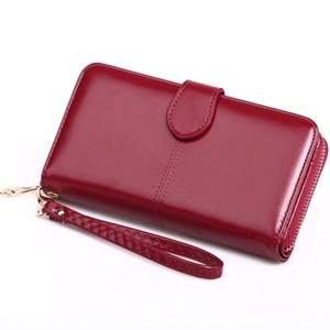 Deep red oily leather long wallet with zipper, wrist strap and decorative buckle