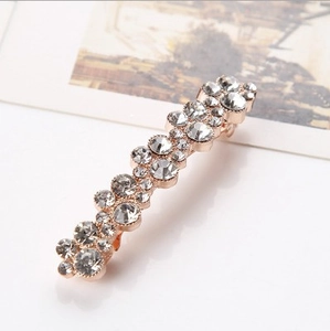 Detailed view of rose gold alloy hair clip with sparkling round crystal rhinestones