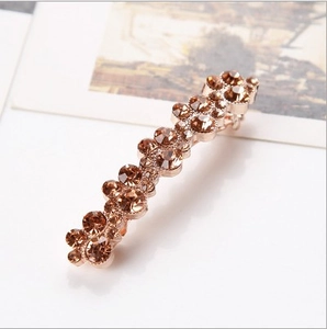 Detail of double-row champagne crystals set in a golden metal hairpin base