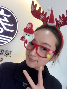 Detail of glowing red reindeer antler headband and snowman glasses for Christmas festive dress-up