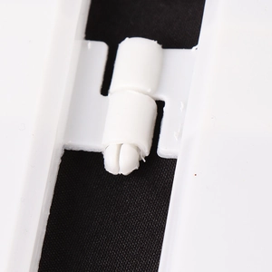 Detailed close-up of white plastic fence hinge connector for Christmas tree base decoration