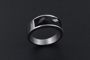 Macro view of rectangular black gemstone set in a brushed stainless steel band