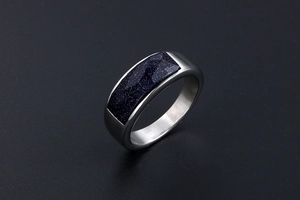 Detailed macro view of silver steel ring with rectangular blue sandstone inlay