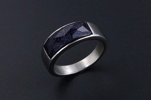 Macro shot of silver stainless steel ring with a rectangular blue sandstone inlay
