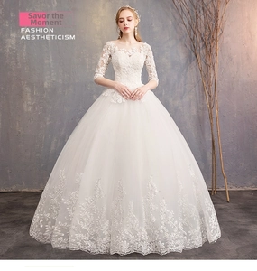 Detail of elegant lace embroidery on the hem of a white off-shoulder bridal gown