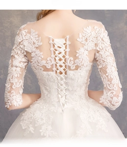 Exquisite back detail of bridal gown featuring floral lace embroidery and lace-up closure