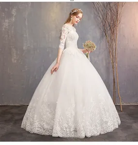 Side view of white bridal gown featuring elegant lace embroidery and semi-sheer half sleeves