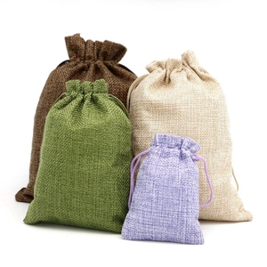 Linen drawstring pouches for jewelry in various sizes and colors on white background