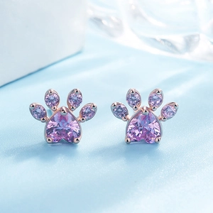 Detail showing rose gold cat paw stud earrings with heart-shaped pink zircon stones