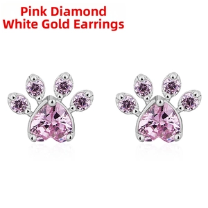 Macro detail of cat paw stud earrings with heart-shaped pink quartz and rose gold plating
