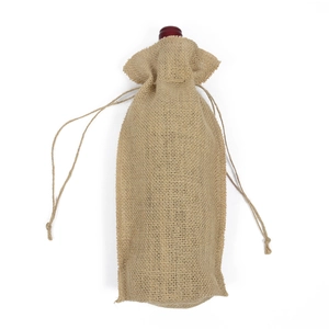 Close-up of textured natural burlap wine bag with drawstring closure on white background