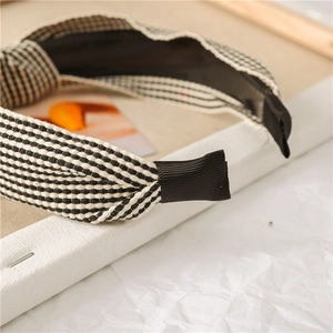 Detail of classic black and white plaid fabric headband with ribbed edge for comfort
