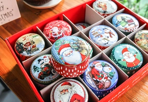 Christmas tin box gift set with festive patterns on a wooden tabletop arrangement