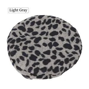 Detail shot of light grey leopard print beret made of textured wool felt material