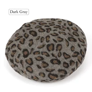 Detailed close-up of dark grey leopard print beret made of soft wool felt texture
