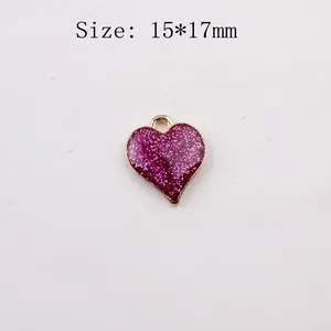 Detail of 15x17mm purple glitter heart pendant with gold metal edges and size marking