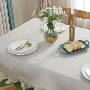Linen cotton tablecloth with ruffle edge design on a dining table in Nordic style