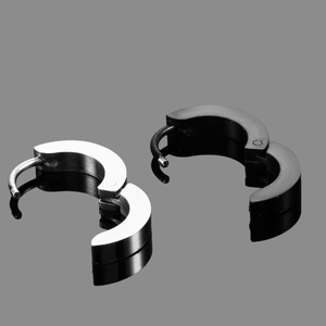 Polished silver and black stainless steel hoop earrings shown from a top-down view