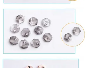 Macro detail of hexagonal marble nail charms with sparkling central rhinestones