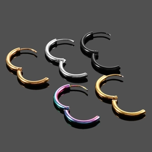 Detailed view of five round stainless steel earrings in gold, silver, black and rainbow finish
