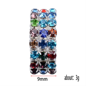 Detailed macro view showing a 9mm wide silver ring with three rows of multi-colored crystals