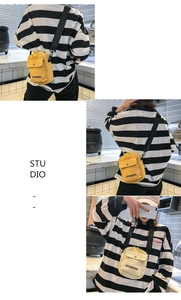 Detailed view of canvas mini crossbody bags in yellow and beige with adjustable black straps