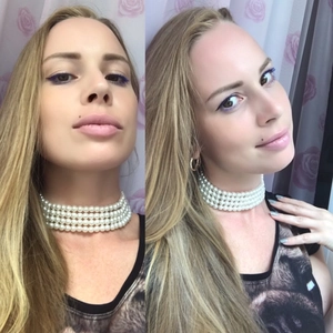 Detail view of a four-layer white faux pearl choker necklace worn by a female model