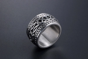 Macro view of silver vintage Celtic knot embossed design on a wide stainless steel ring
