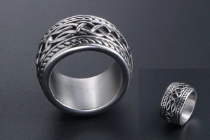Macro shot of wide band stainless steel ring with vintage woven celtic texture