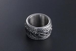 Detail showing vintage Celtic knot engraving on a wide titanium steel ring for men