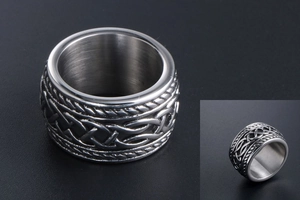 Close-up of Celtic knot patterns and rope textures on men's vintage steel band ring