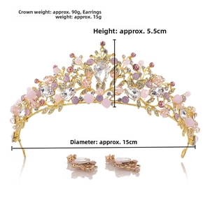 Detail view of gold baroque bridal tiara and earrings set with pink crystals and rhinestones