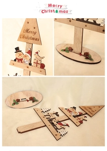 Detail of wooden Christmas tree blocks featuring hand-painted snowman and reindeer patterns