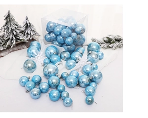 Close-up of ice blue Christmas ball ornaments in various sizes with shiny metallic finish