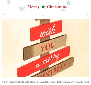 Macro detail of the wooden Christmas tree block with festive greetings and warm textures