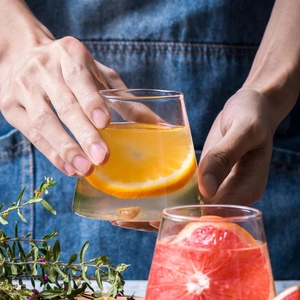 Creative Mount Fuji glass cup with orange slices in a minimalist lifestyle setting