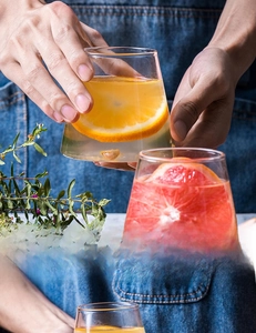Macro shot of Mount Fuji glass cup filled with juice, showcasing its ergonomic bottom grip
