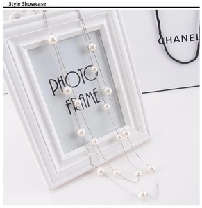 Close-up of double-layer long pearl necklace with white beads on a silver chain