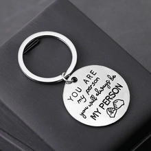 Close-up of zinc alloy keychain engraved with You Are My Person text and hook pattern