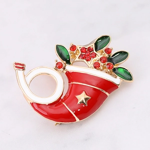 Detail of Christmas stocking brooch with red enamel, gold star and sparkling rhinestones