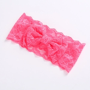 Detail of rose red lace headband with a large bow on a clean white background