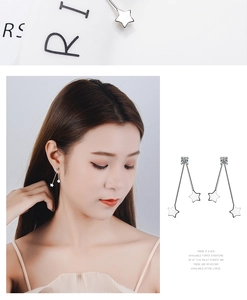 Macro detail of silver star tassel earrings with zircon inlay and long fringe design