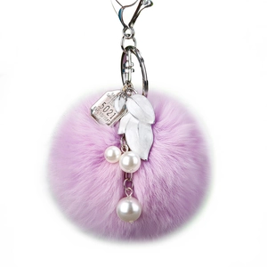 Sparkling faux fur heart keychain in light purple with metal leaf and pearl accents