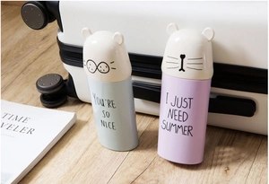Detail view of cute light blue and pink purple cartoon animal travel toothbrush cases