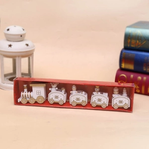 Detail of white and gold wooden Christmas train set with five sections and snowflake patterns