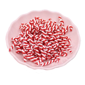 DIY Christmas polymer clay candy cane accessories for crafts in a pink scalloped bowl