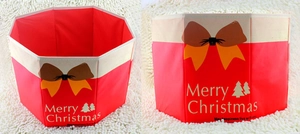Detail of red non-woven Christmas tree collar with Merry Christmas print and yellow bow